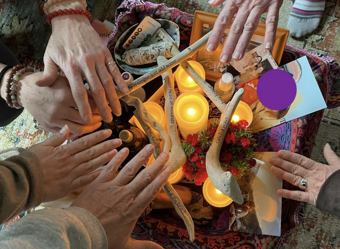 women's hands around a candle