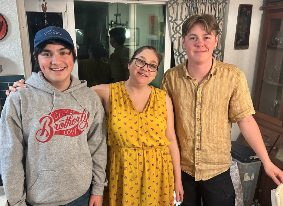 Woman standing between two teen sons