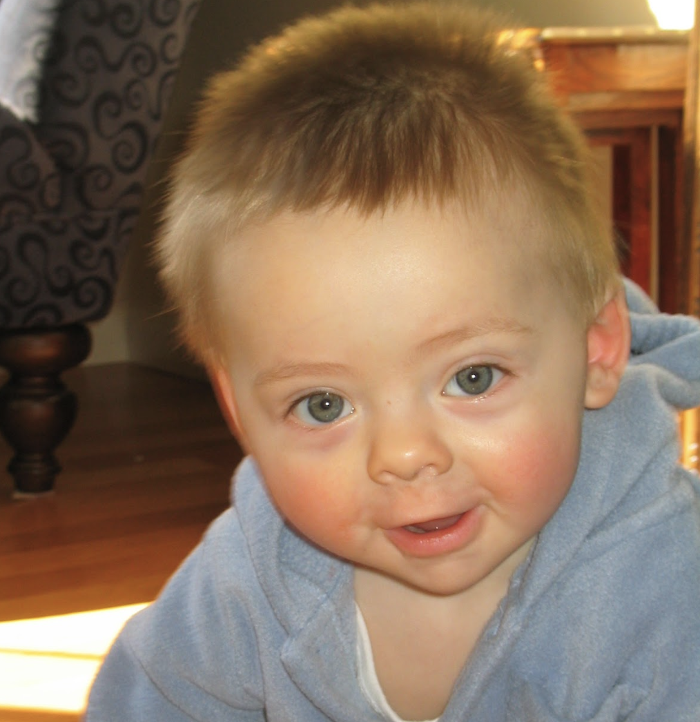 Baby face with blue eyes and little smile